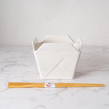Everything tastes better in a to-go container…but this one is designed to be reusable

Bowl Size: 5" Dia x 4"H
Chopsticks 9"L
Capacity: 16 fl oz
Material: Ceramic
Microwave and Dishwasher Safe
Origin: China