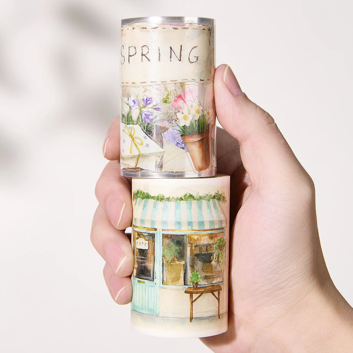 Celebrate the season of new beginnings with a design that marries architecture and nature. Our Spring Café Wide Tape is a watercolor love letter to the season, featuring quaint cafe facades almost hidden behind explosions of pastel bouquets and greenery.