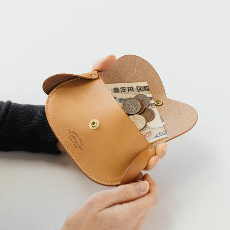A wallet with a dog motif.

It is durable and can be used for many years, and the design is cute and makes a nice accent.