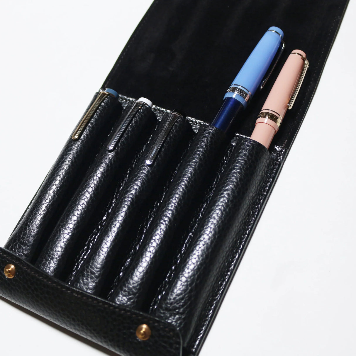This case for fountain pens can hold five pens individually.

Lined with pig suede for a luxurious look and feel, your precious pens will be well protected and carried.

The buttons are original, made of solid brass and stamped with T.S.L.

SIZE: L13cm × H15cm


COLOR: Camel / Brown / Black


MATERIAL :&nbsp;Cow leather

Leather Products:

The leather used in this product is natural leather.
We do not use scratches that lead to tears or rips, but we use scratches and wrinkles that are originally