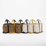 The SUPERIOR LABOR Mini Tote Bag

A simple, timeless canvas bag designed for everyday life.

Its compact size is just right for daily essentials, while the four outer pockets keep your glasses, keys, favorite pens, or notebook neatly organized.

They make it easy to stay tidy and add a touch of extra storage without changing the clean look of the bag.

Size: W37×H23.5×D12.5cm
Canvas Products
Painted areas may be affected by friction or water, which can cause color transfer. Please handle with care.