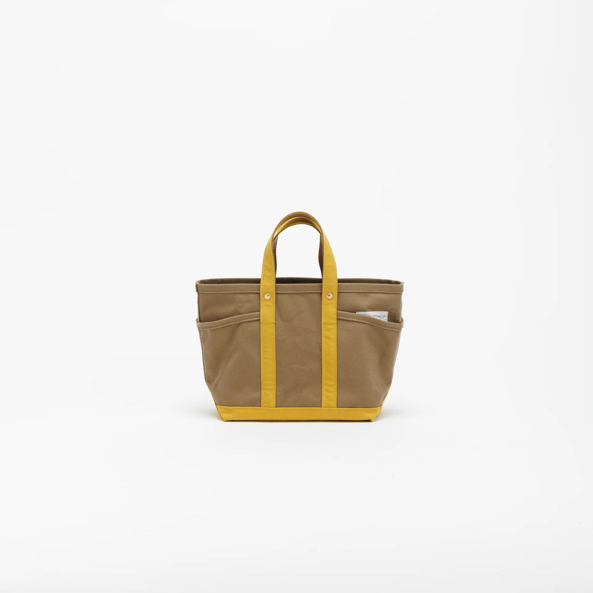 The SUPERIOR LABOR Mini Tote Bag

A simple, timeless canvas bag designed for everyday life.

Its compact size is just right for daily essentials, while the four outer pockets keep your glasses, keys, favorite pens, or notebook neatly organized.

They make it easy to stay tidy and add a touch of extra storage without changing the clean look of the bag.

Size: W37×H23.5×D12.5cm
Canvas Products
Painted areas may be affected by friction or water, which can cause color transfer. Please handle with care.