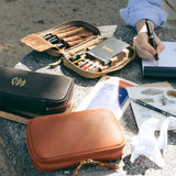 We crafted this leather case for those who love to write —for people who value the quiet moments spent with pen and paper.

Open it up, and on the right side, every surface that touches your precious pens is lined with soft suede, gently protecting them from scratches.&nbsp;On the left, two rows of pockets hold your memo pads, casual pens, or other writing companions, keeping everything neatly in place and ready whenever inspiration strikes.

Size: W13×H20×D4.5cm
About the Leather – Japanese Glove Leather

