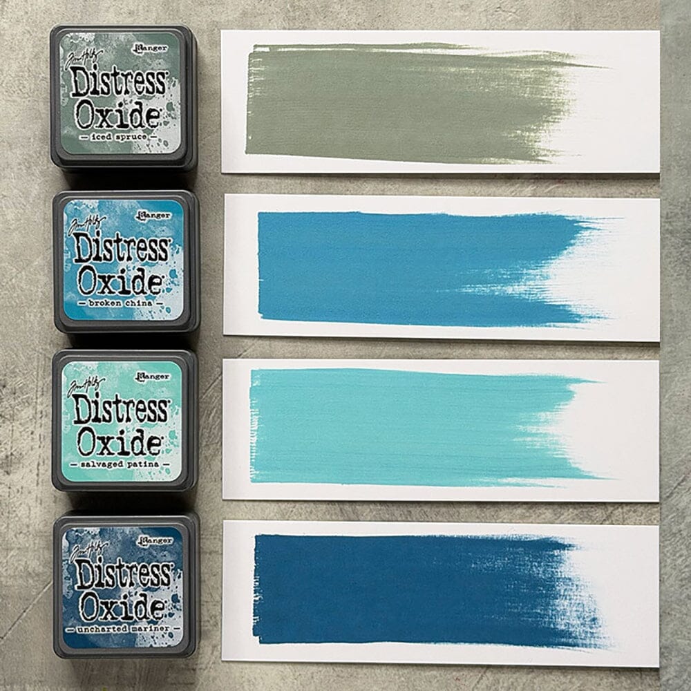 Tim Holtz Distress Mini Oxide Ink Pads are a collection of 1 x 1 cubes featuring water-reactive dye &  pigment ink fusion that creates an oxidized effect when sprayed with water.