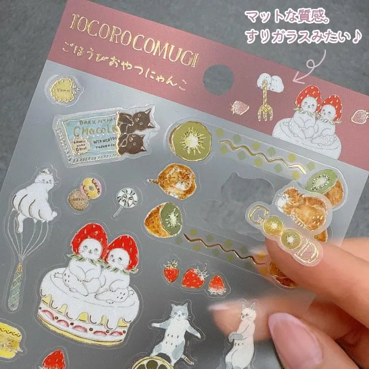 A sticker sheet with cute cats diving into sweet desserts designed by Tokoro Komugi who is known for their soft style of illustration featuring animals! Perfect for decorating letters, notebooks, and more!
