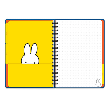 Plan out your year with Miffy! This Undated Tri-Tab Planner is your go-to for year-round organization—start anytime, no dates required! With three cute tabbed dividers, you can easily flip between monthly spreads, weekly planning, and notes. Plus, full-color stickers make tracking your to-dos fun and easy! Each section features a handy pocket for receipts or lists, and the wire-o binding lets it lie flat as you plan. The elastic band keeps everything secure—and doubles as a page marker! Planning just got a 