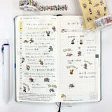 Banda adhesiva washi en forma de personas que viven en un cuaderno