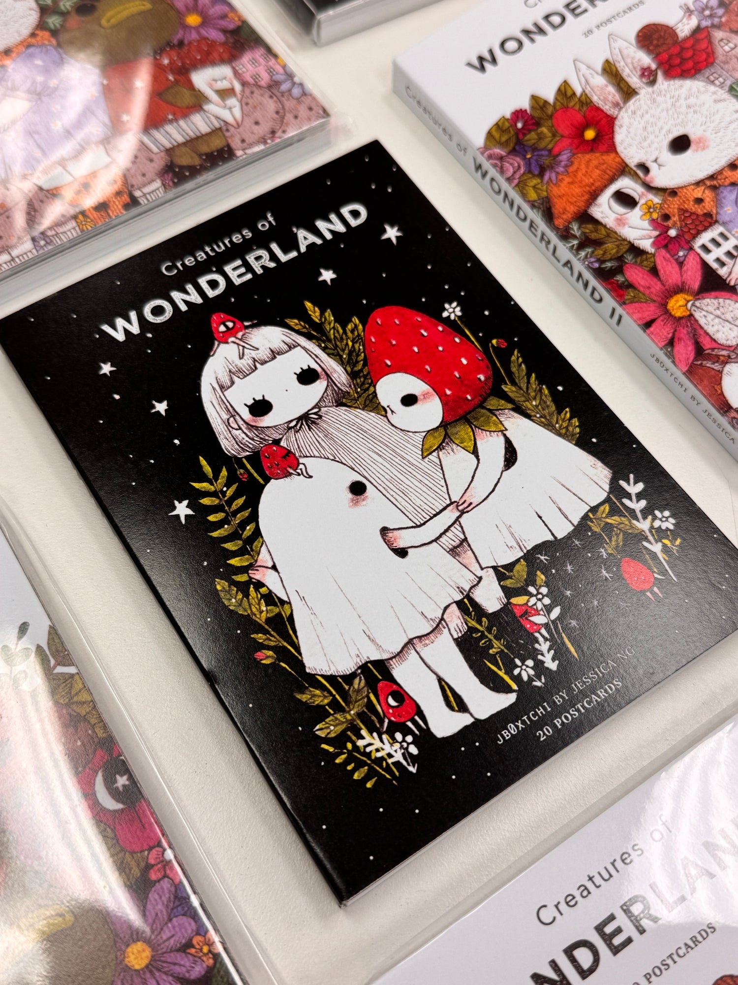 jb0xtchi Postcard Set - Creatures of Wonderland

The Creatures of Wonderland Postcard Set includes 20 postcards featuring artwork illustrated by jb0xtchi (Jessica Ng). jb0xtchi creates stationary and small trinkets from whimsical ideas in the form of painting using ink, watercolor, and gouache.

6in x 4in postcards
20 different designs
All artwork done by Jessica Ng