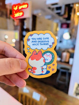 Give yourself (or a friend) a little daily boost with this "You Are Cute and Deserve Nice Things" vinyl sticker! Featuring an adorable chubby cat gazing into a mirror with a sweet self-affirming message, this sticker is the perfect reminder to practice self-love and kindness. The warm, cozy color palette and playful design make it an uplifting addition to your laptop, water bottle, journal, phone case, or anywhere you need a dose of encouragement.