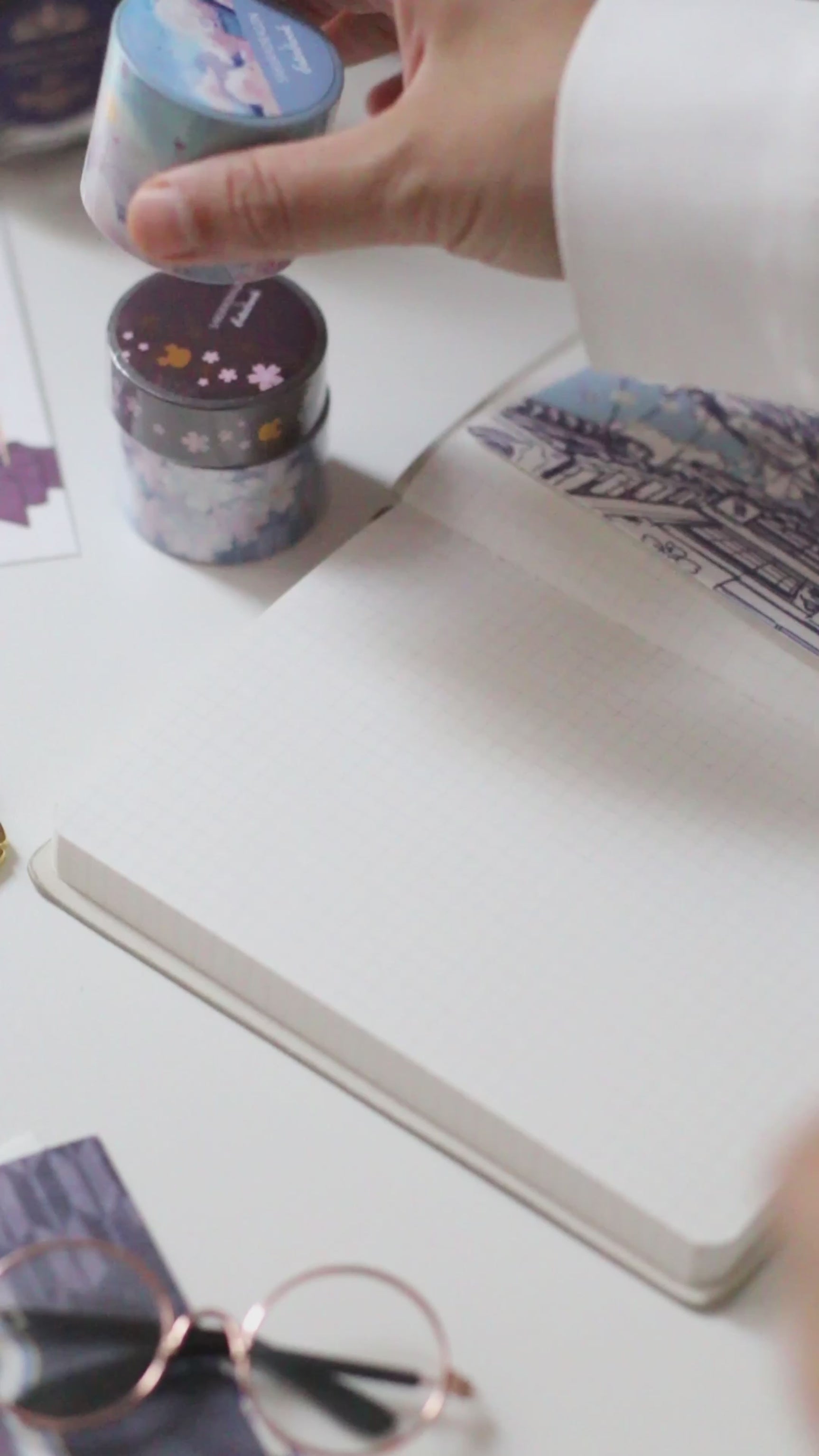 Esterbrook x Sakuradragon Washi Tape - Sky

The Sky Washi Tape turns Cindy Duong's Sakura Street Sky illustration into a continuous scene. Soft clouds and rooftops fill the 3.5 cm-wide tape, with gold foil details appearing throughout the design. Each roll contains five meters for decorating journals, letters, and stationery projects.&nbsp;